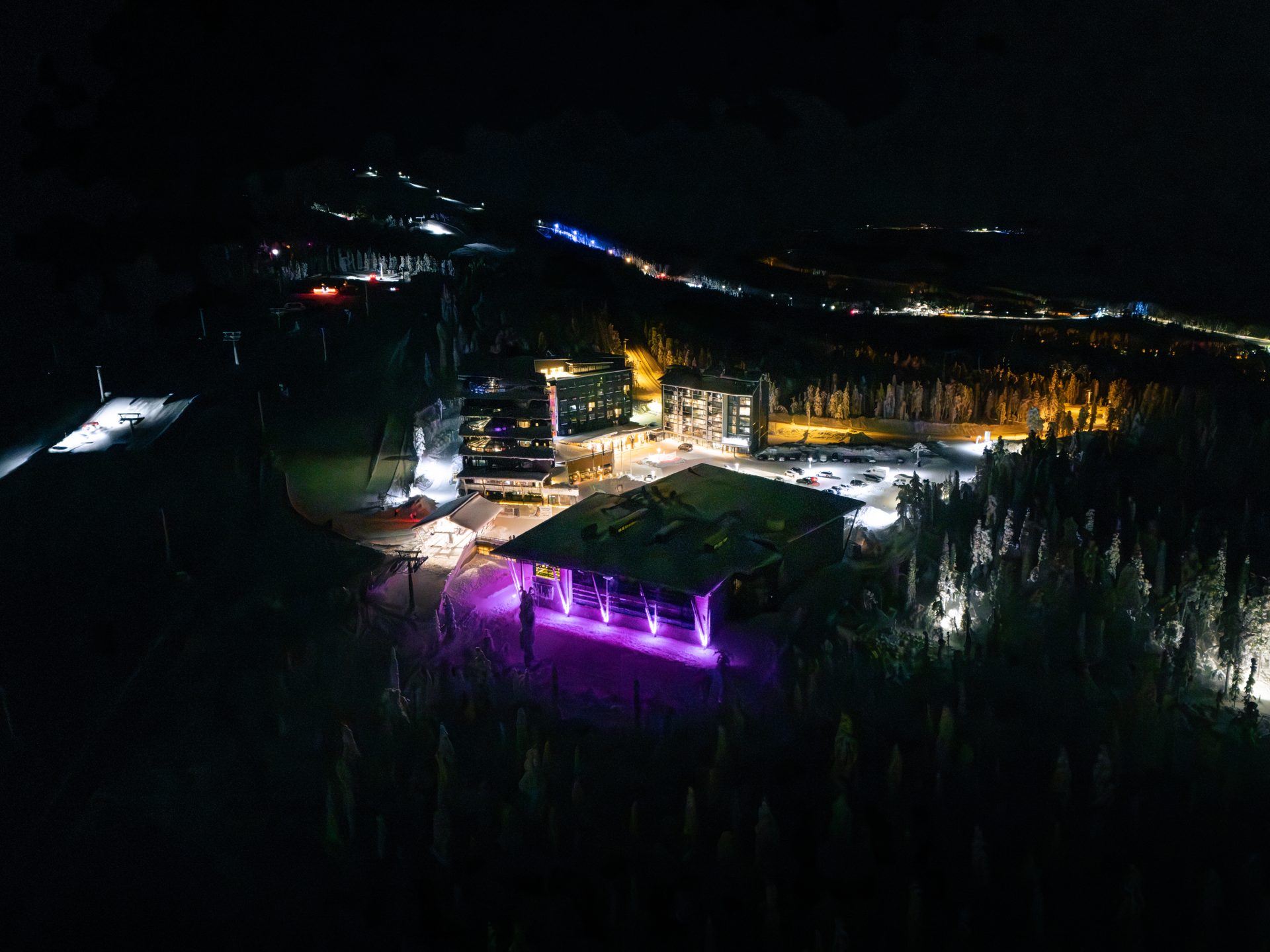 Hotel Levi Panorama ja Levi Summit valaistuina yöllä Levin valaistujen rinteiden yllä