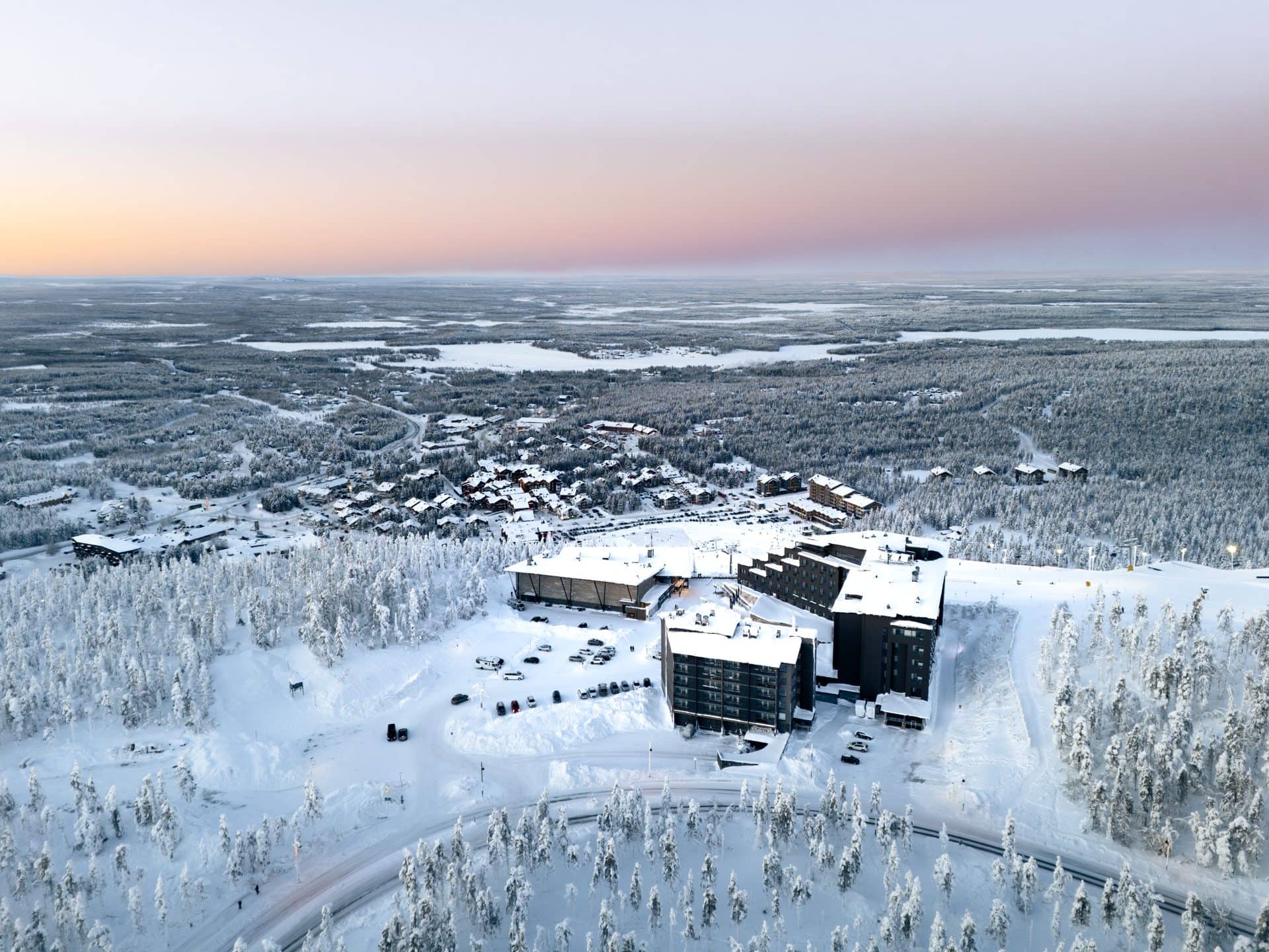 Ilmakuva Levin kylästä, Hotel Levi Panorama ja Levi Summit lumisella rinteellä sen yllä